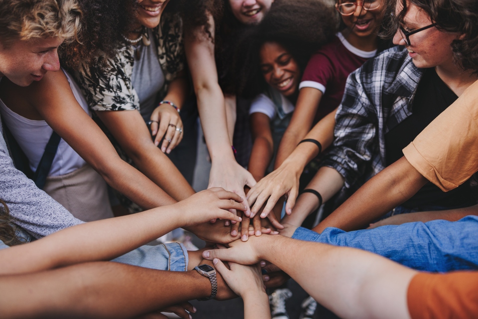 Group of people gathering hands together